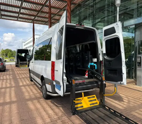 Professionele rolstoeltaxi chauffeur helpt klant in Ede
